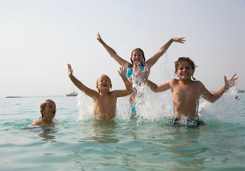 Kids jumping and splashing in the water