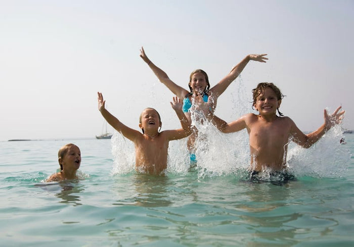 Kids jumping and splashing in the water